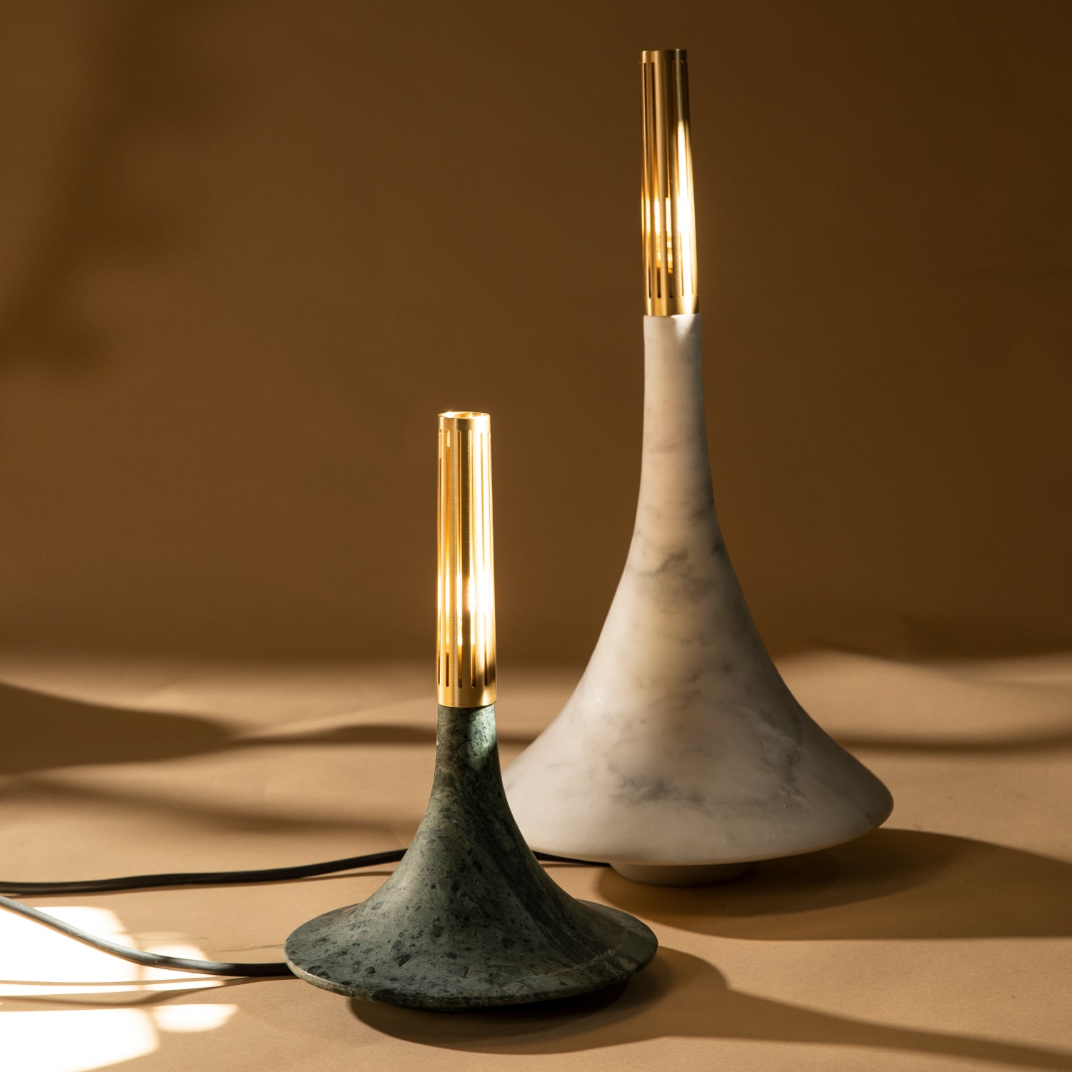 Two marble design pieces in their marble variant, in green and with colors