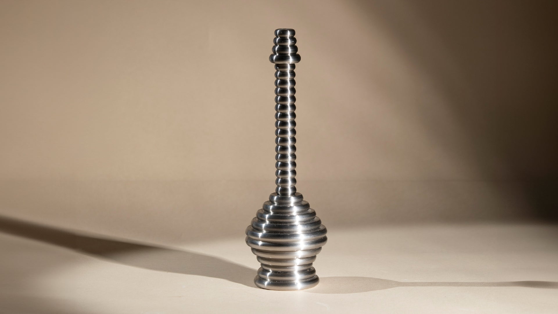 Front view of the sprinkler, with the light reflecting on its metal material