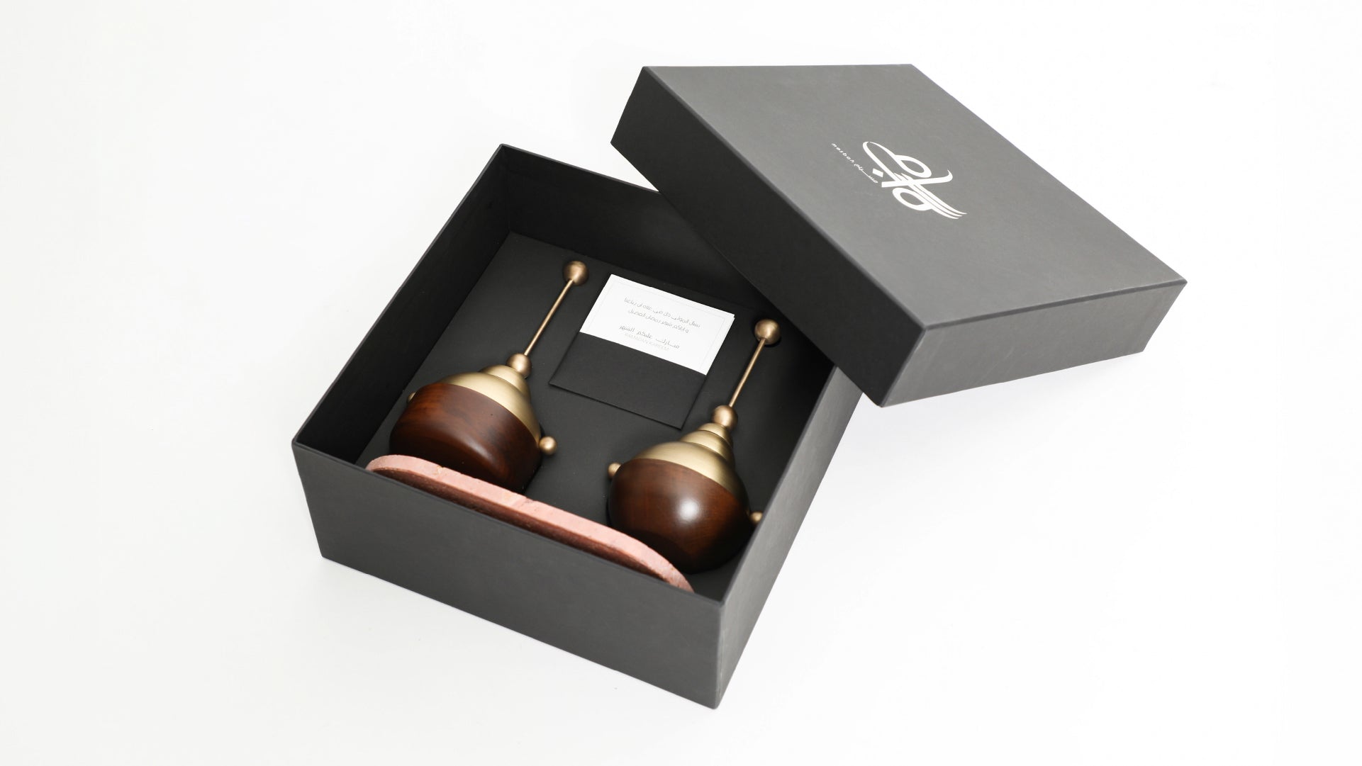 The open box containing two incense burners and their ceramic stand