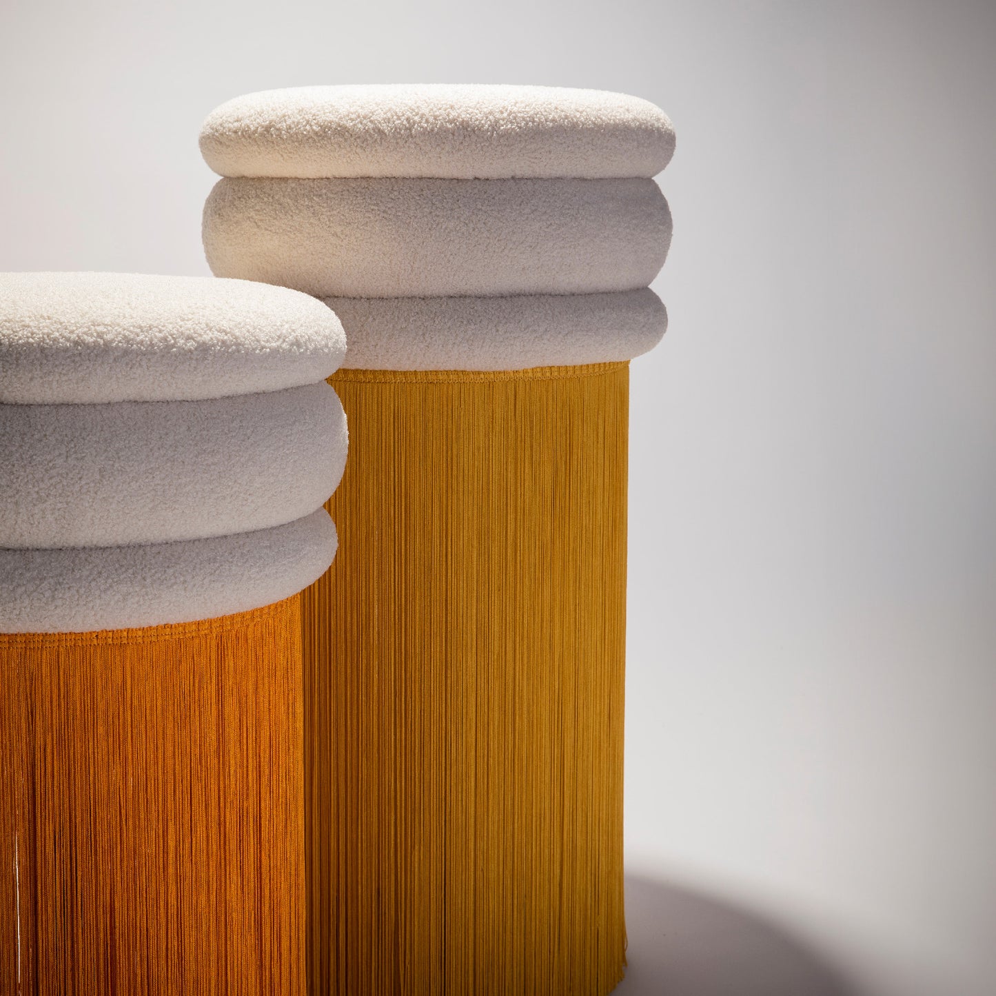 Focus on two stools from the Tessels Collections in yellow and orange colors