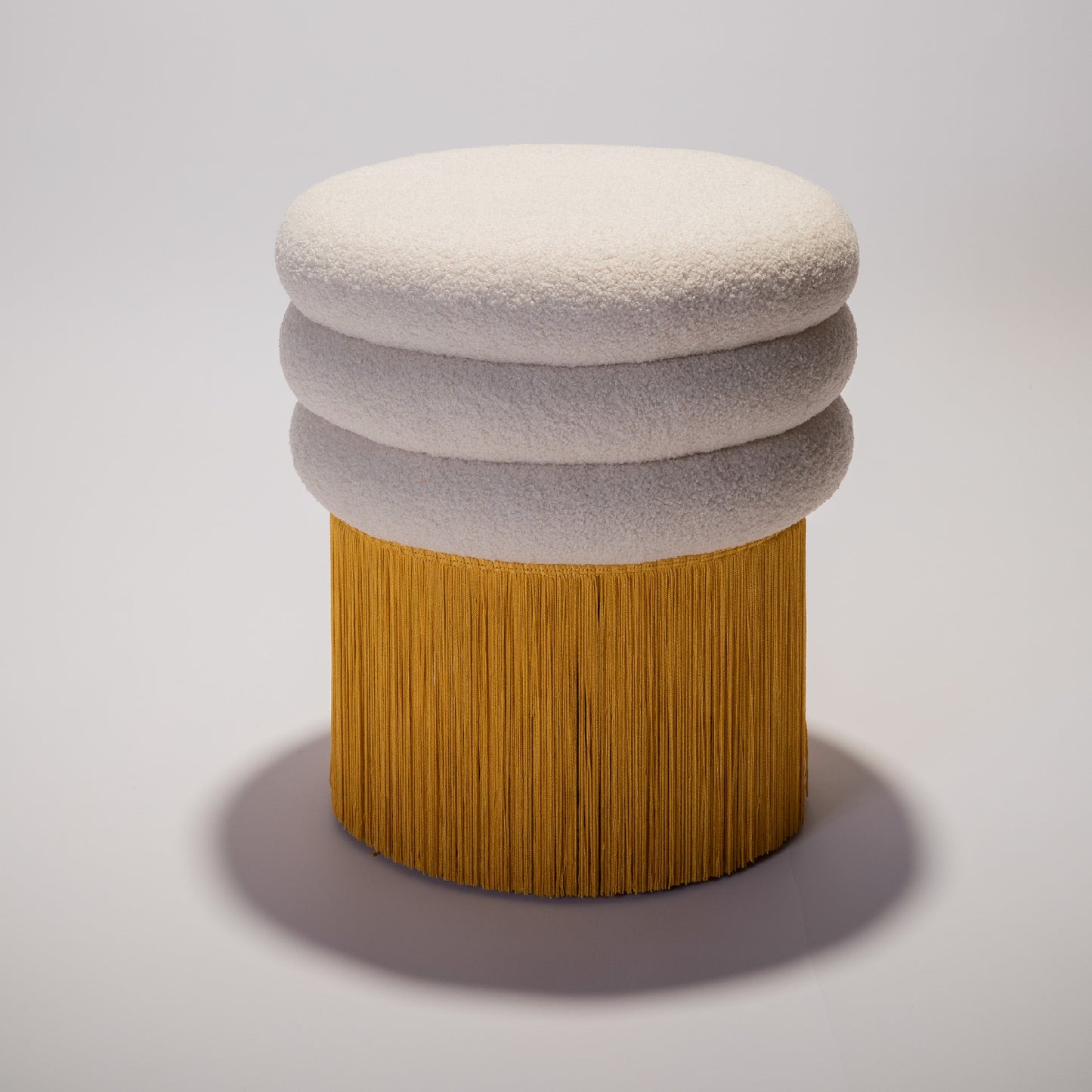 Short yellow stool from the Tessels Collection, front view and centered