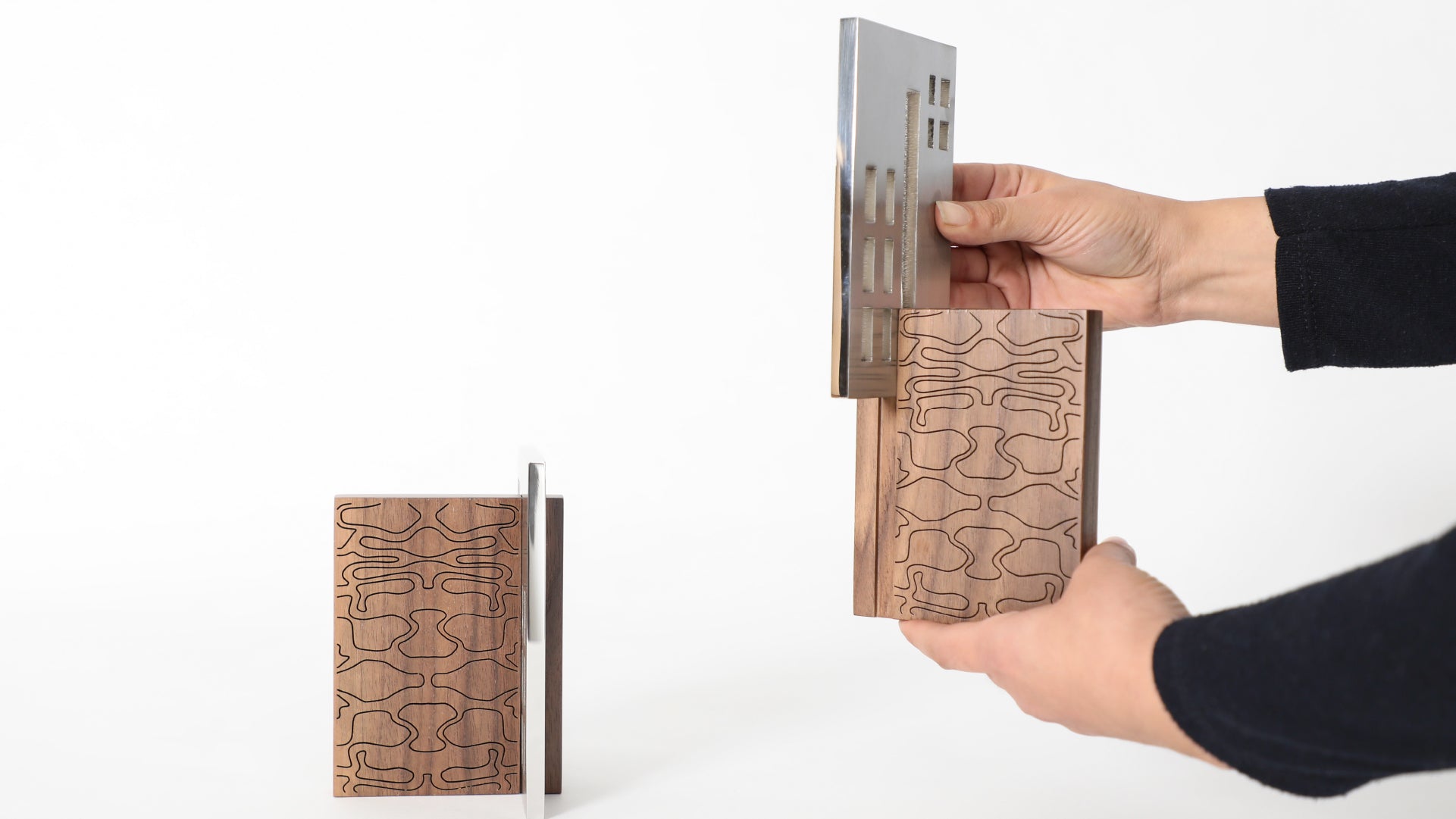 Hands displaying how to use the book holder